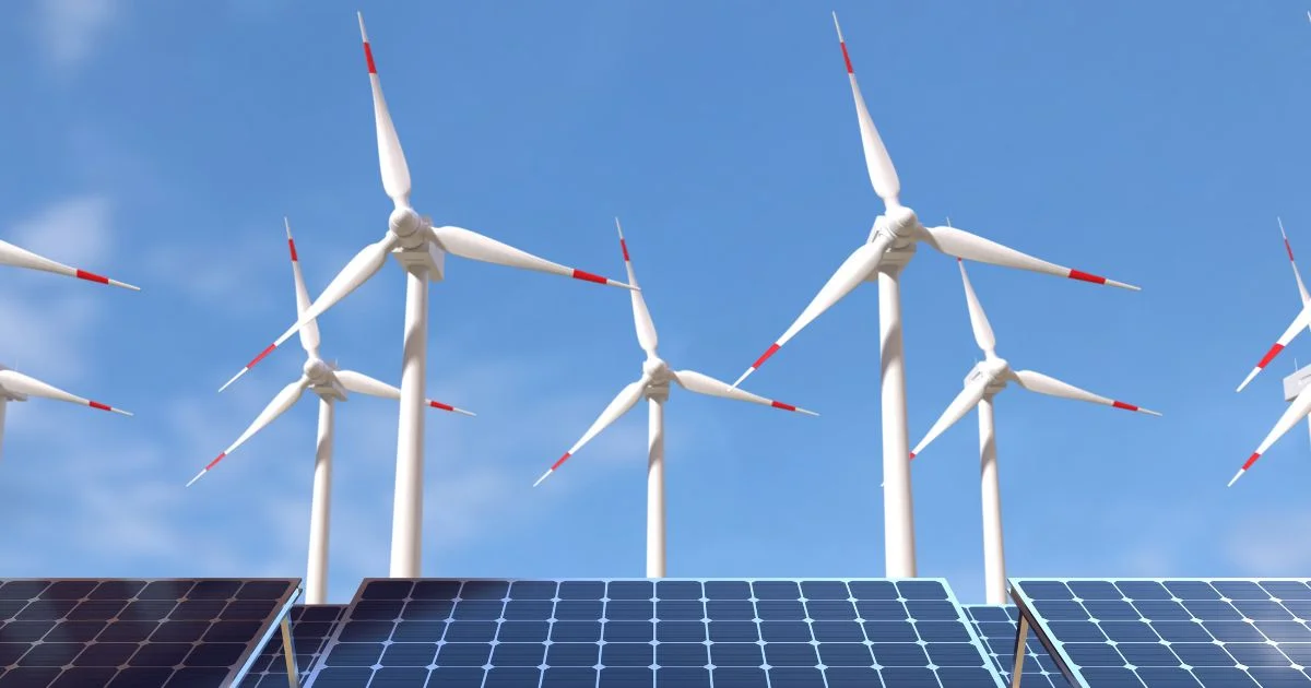 Solar panels and wind turbines generating renewable energy under a clear blue sky.